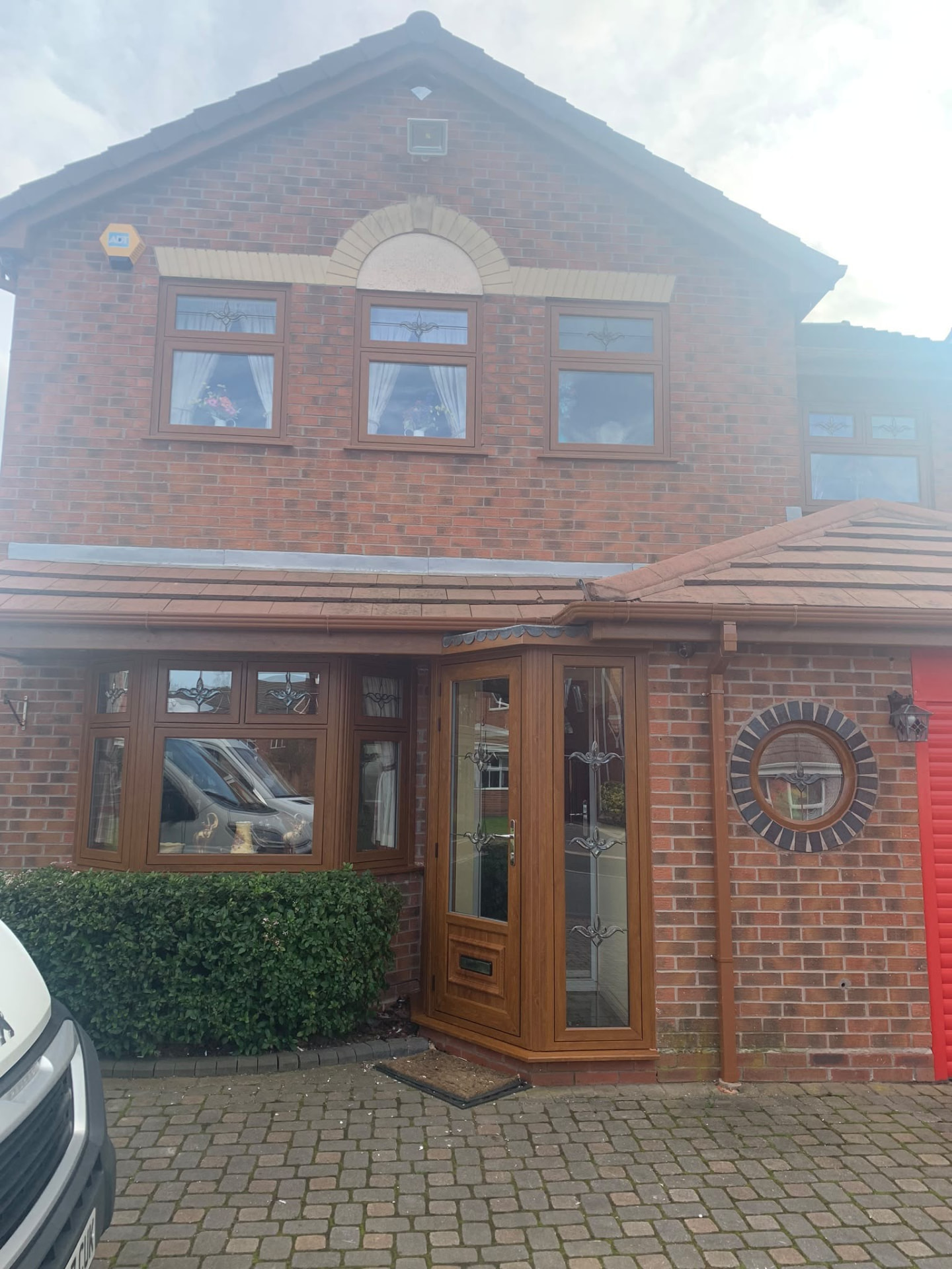 Oak-effect double glazed UPVC windows and porch door fitted by Draycote Windows