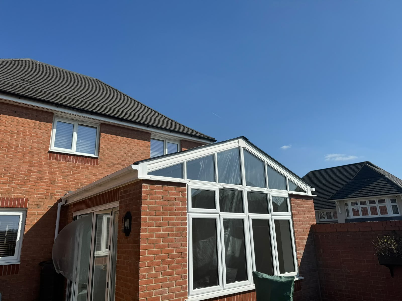 Gable conservatory with a new insulated tiled warm roof and glazed apex