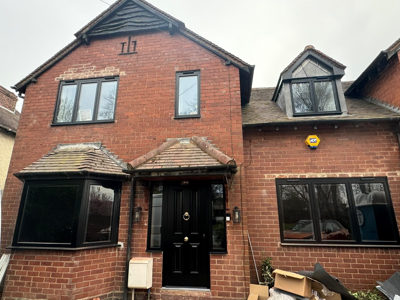 Anthracite grey double glazing fitted throughout a detached red brick house