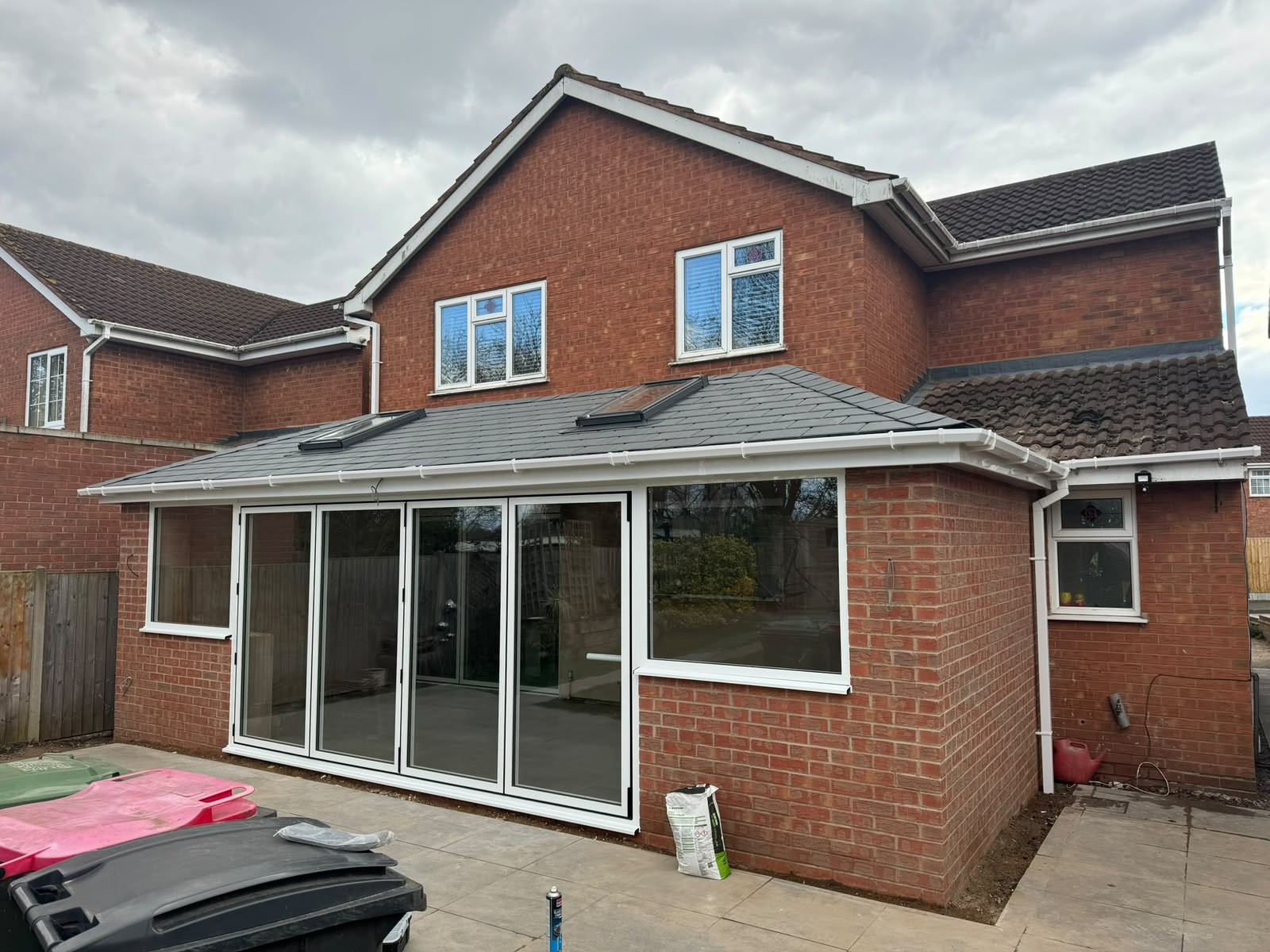 Tiled warm roof over a rear conservatory with white bi-fold doors