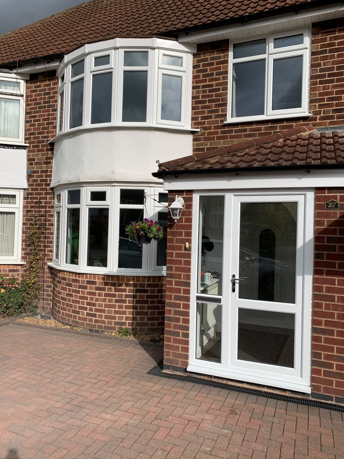 White UPVC bay window and porch installed on a semi-detached home by Draycote Windows