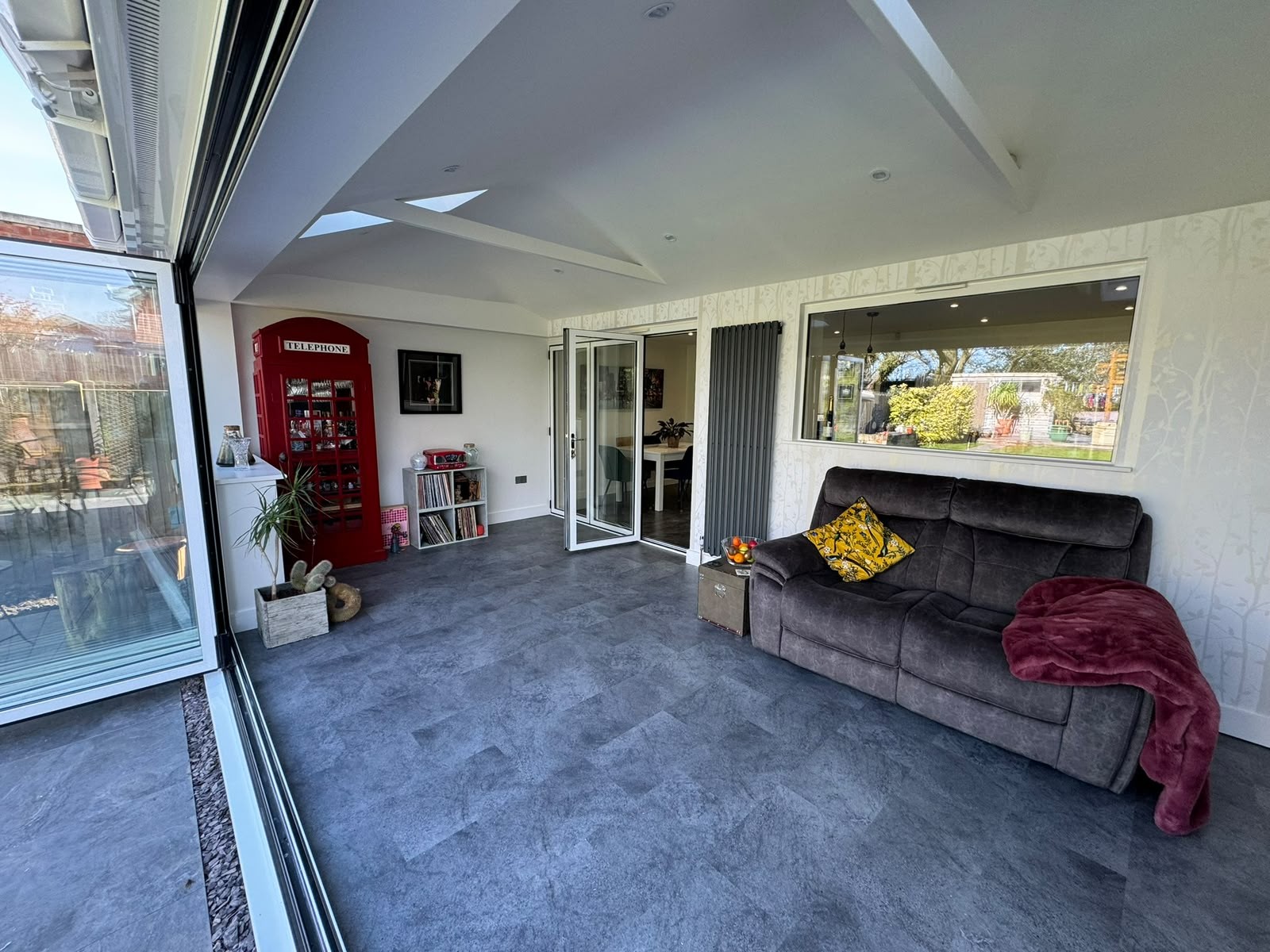 Interior of a completed rear extension with bi-fold doors and tiled warm roof