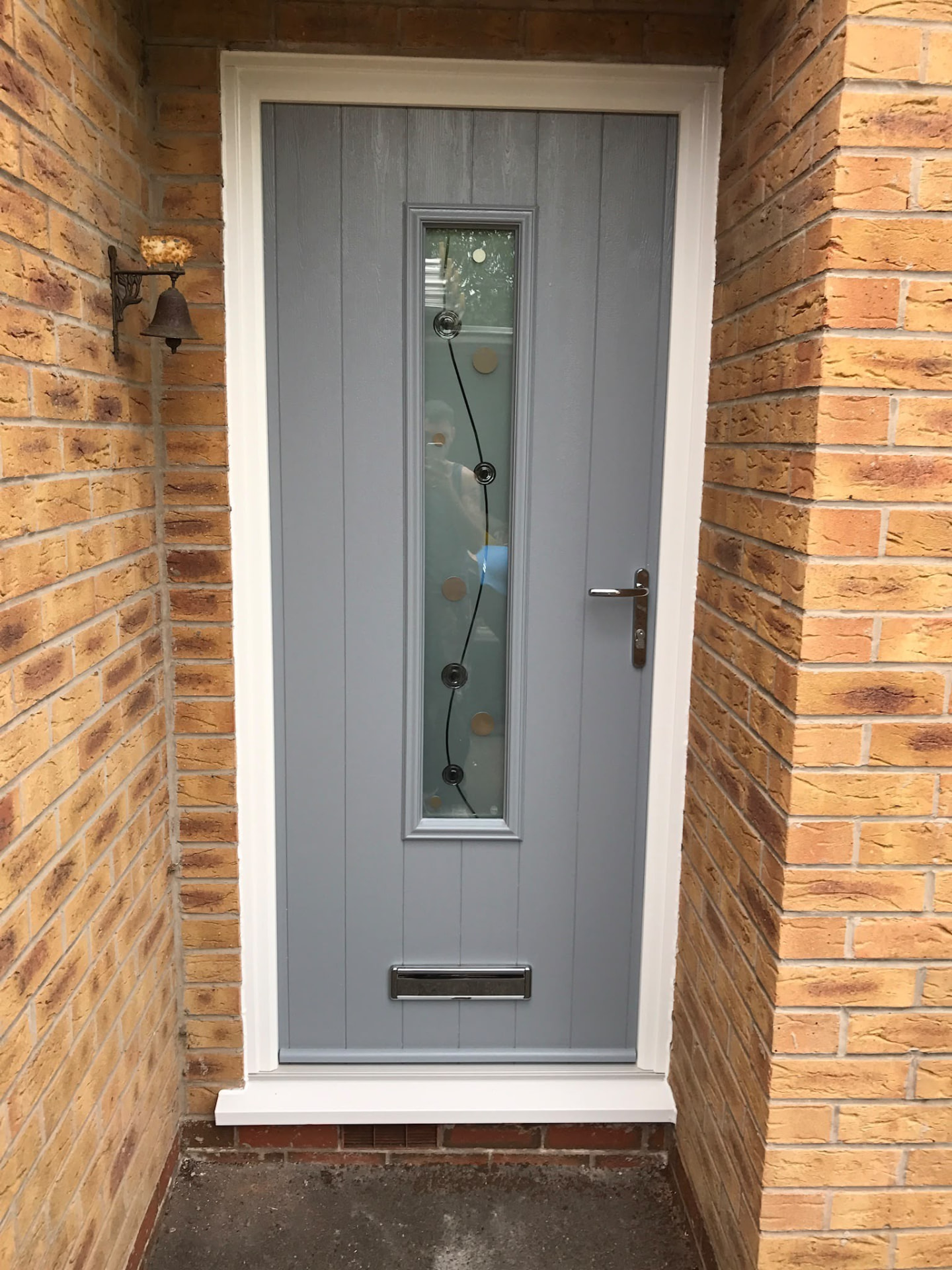 Light grey composite front door with slim glazed panel fitted by Draycote Windows