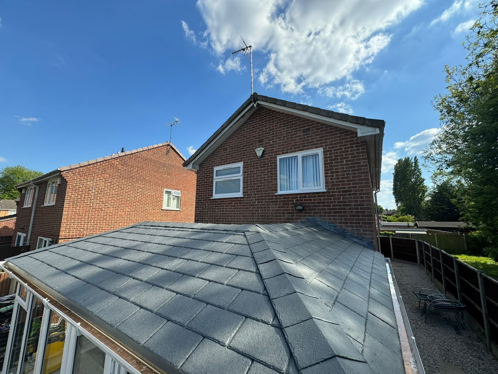 Slate-effect tiled warm roof fitted over a conservatory by Draycote Windows