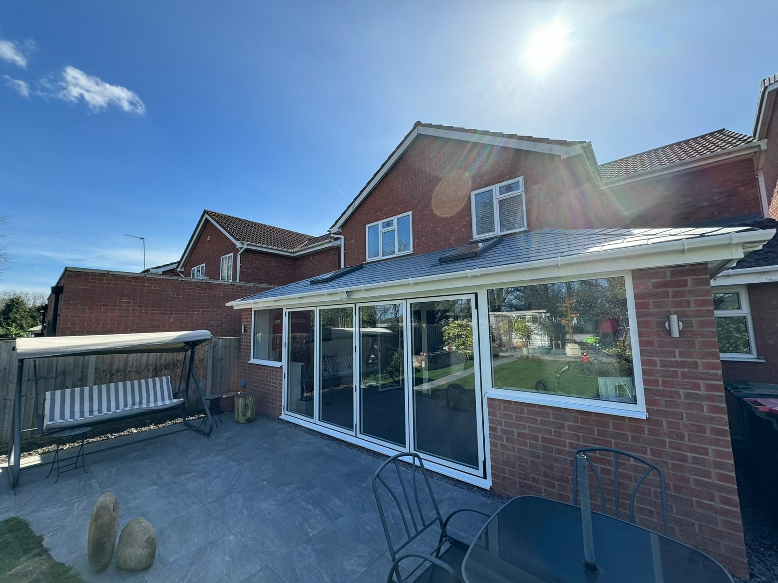 Wide rear elevation of a conservatory with a new insulated tiled warm roof