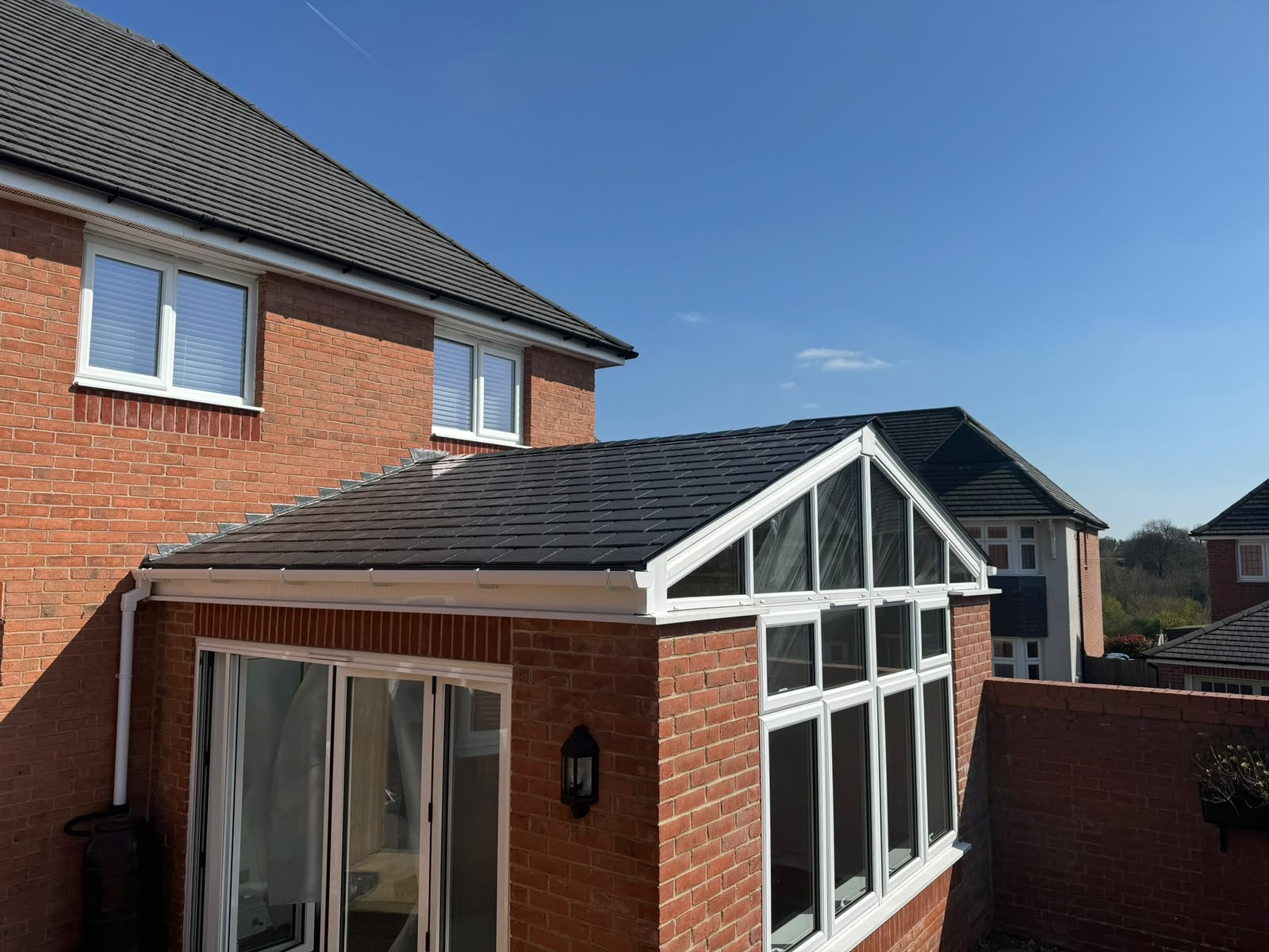 Gable-fronted tiled warm roof installed on a rear sun room