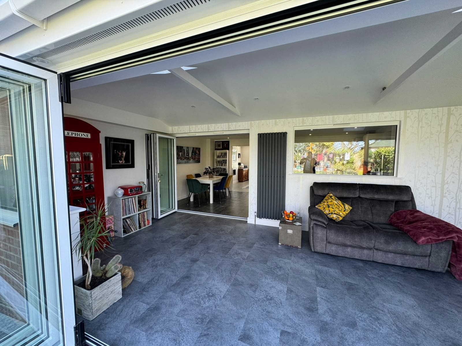 Bi-fold doors open onto a patio from a completed rear extension