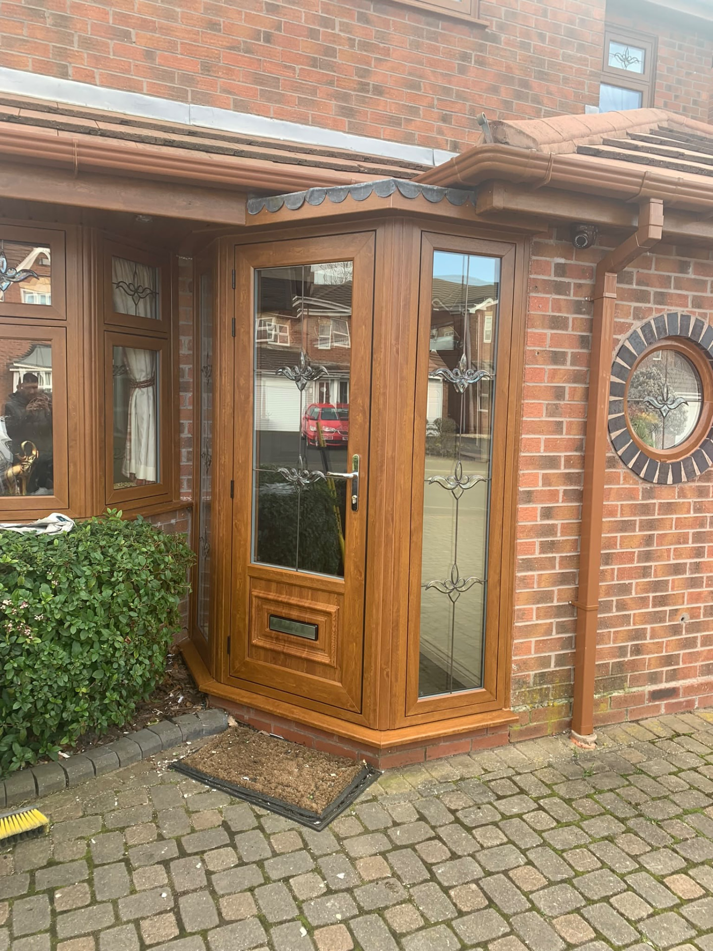 Oak-effect UPVC front door and porch frame fitted by Draycote Windows