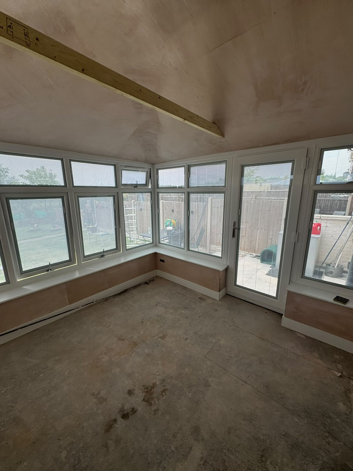 Commercial glazing installation with white framed windows and a glazed door fitted to a newly built unit
