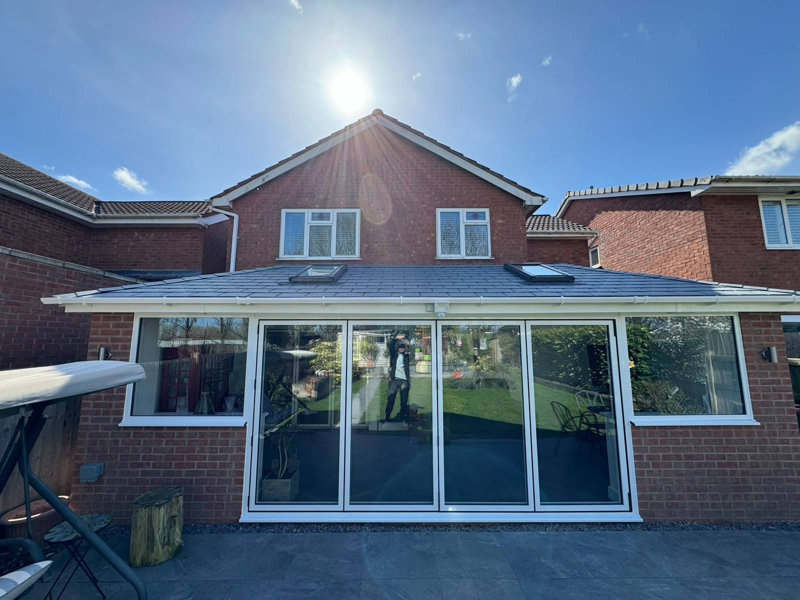 Wide rear conservatory with a new insulated tiled warm roof and roof windows