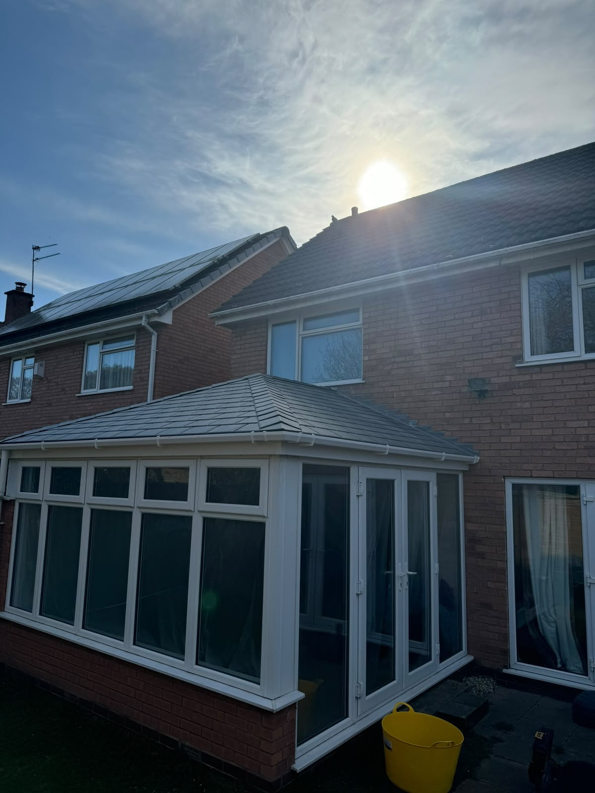 Conservatory with a new insulated tiled warm roof on a detached home