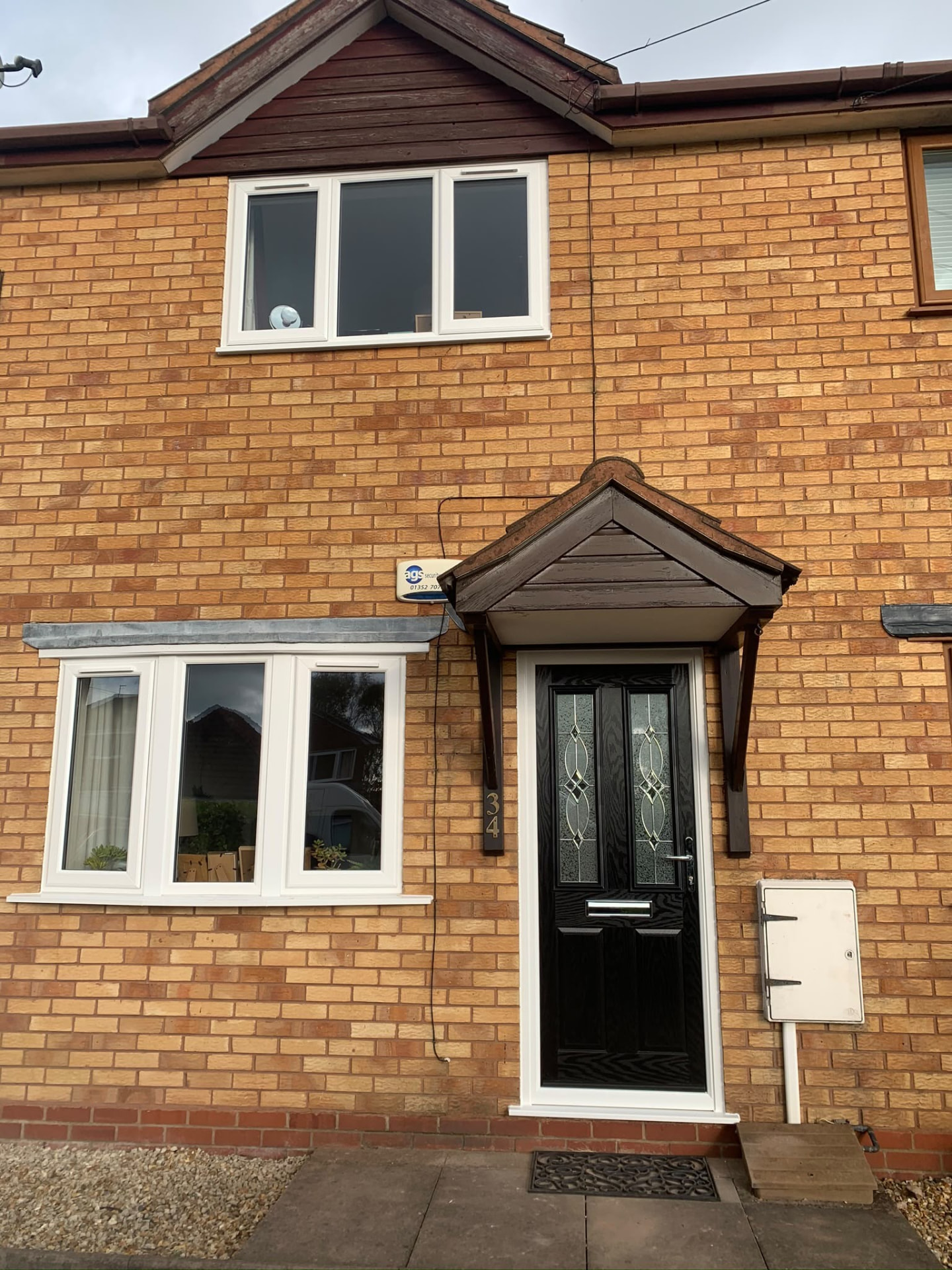 White A-rated double glazed windows and a black composite door on a family home